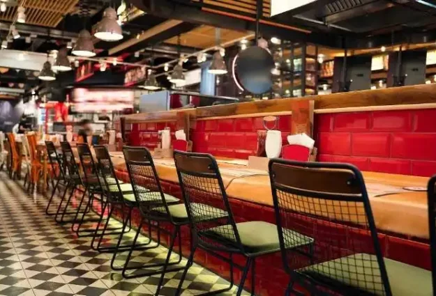 a restaurant with a long counter and chairs